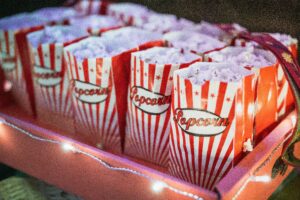 A serving tray holding multiple bags of movie popcorn.